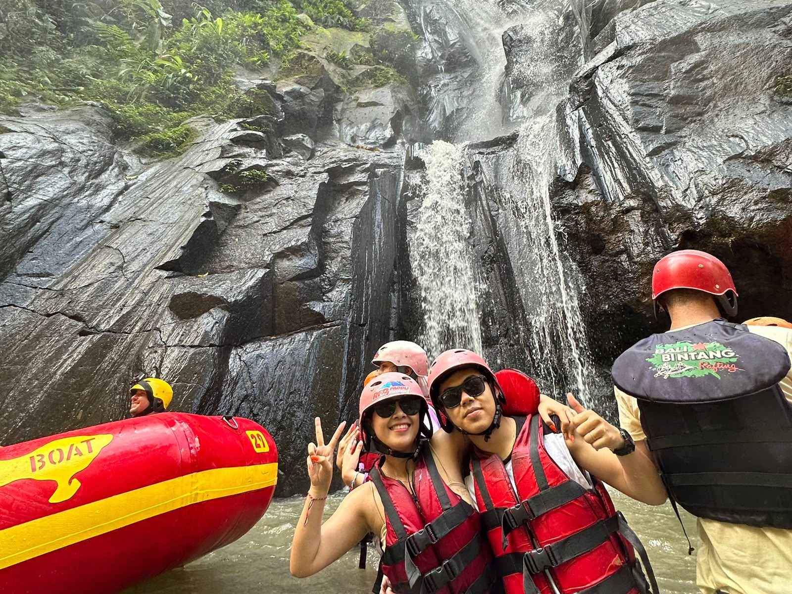 Couple enjoying exciting white water rafting along scenic jungle river in Bali