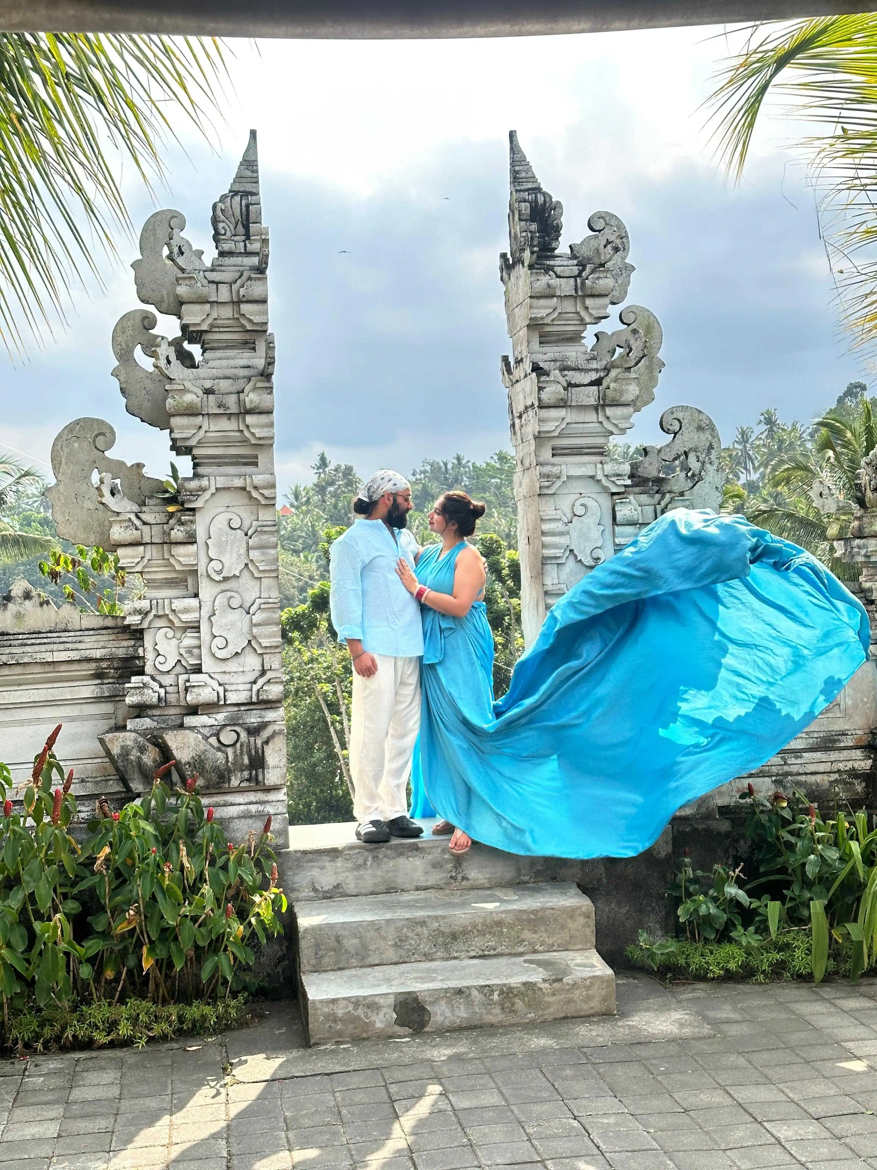 Couple enjoying romantic scenic sunset on Bali cliff edge